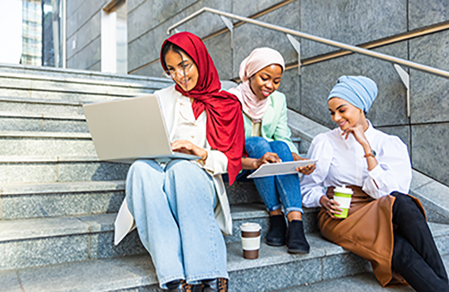 Beautiful muslim girl wearing hijab bonding outdoors